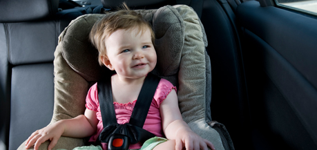 Baby sitting in a baby seat.