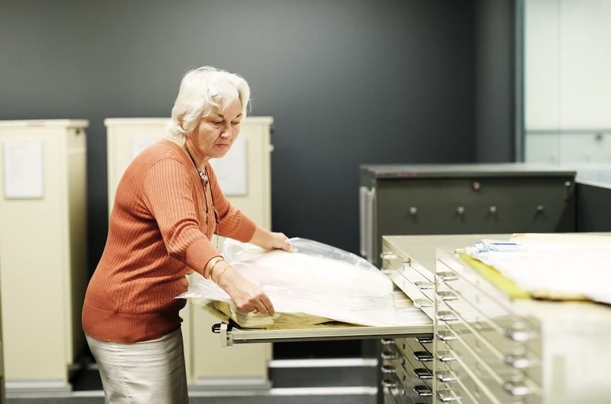 Large paper maps are filed in drawers